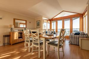 a kitchen and dining room with a table and chairs at West Cottage - Elie in Earlsferry
