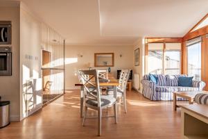 a living room with a table and chairs and a couch at West Cottage - Elie in Earlsferry +34 photos