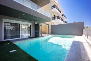 a swimming pool in front of a house at Athenean Pool Break in Athens