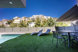 a patio with a table and chairs and a pool at Athenean Pool Break in Athens