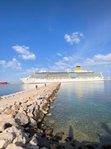 a cruise ship on the beach with a cruise ship in the background at Apartment White Rose in Bar