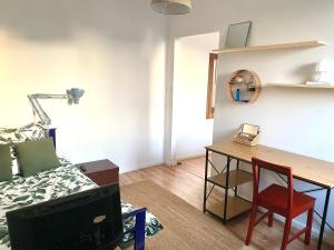 a living room with a table and a bed at Grądy-Woniecko Place in Grądy