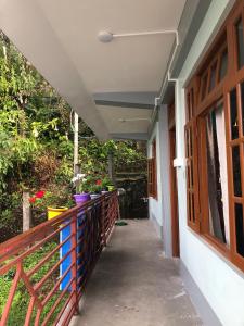 a balcony of a house with flowers on it at Fable homestay in Pedong