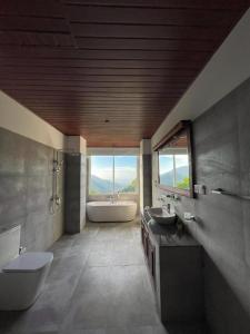 a bathroom with two sinks and a tub and a toilet at Crystal Spring Luxury Hotel in Ella +62 photos