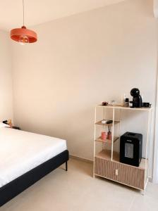 a bedroom with a bed and a tv on a shelf at Giuditta Room C in Ciriè