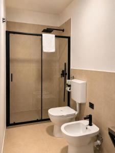 a bathroom with a shower and a toilet and a sink at Giuditta Room C in Ciriè