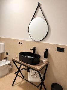 a bathroom with a black sink and a mirror at Giuditta Room C in Ciriè