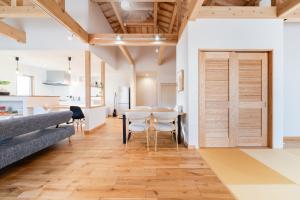 a kitchen and dining room with a table and chairs at タイガーMiyako in Miyako-jima