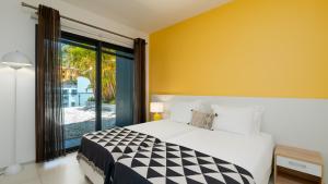 a bedroom with a bed and a large window at Villa Skylark - by LovelyStay in Ponta do Sol +83 photos