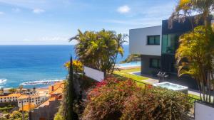 a house with a view of the ocean at Villa Skylark - by LovelyStay in Ponta do Sol