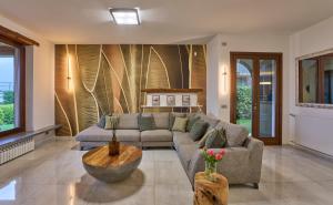 a living room with a couch and a table at Villa Vittoria with private heated pool & shared sauna - Bellagio Village Residence in Oliveto Lario +19 photos
