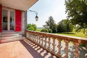 a porch of a house with a red door at Maison de famille au coeur de son vignoble in Lorignac