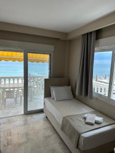 a bedroom with a bed and a view of the ocean at Olympic Beach Rooms in Olympic Beach