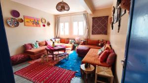 a living room with a couch and a table at Premium Flat Agadir - Immersive rental --- Maison Bleue --- Fast wifi in Agadir