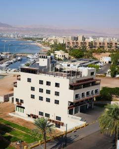 an aerial view of a white building with a marina at Saraya Abdeen Hotel in Aqaba