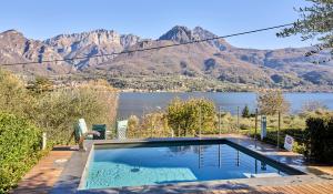 a swimming pool with a view of a mountain at Villa Vittoria with private heated pool & shared sauna - Bellagio Village Residence in Oliveto Lario