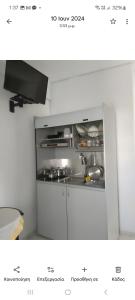 a white kitchen with a stove and a sink at Avra in Alonnisos +37 photos