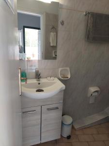 a bathroom with a sink and a mirror at Avra in Alonnisos