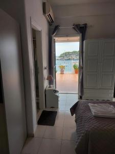 a bedroom with a bed and a view of the water at Avra in Alonnisos