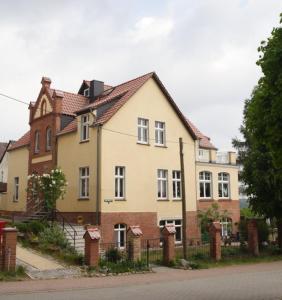 a large house with a fence in front of it at Villa am Oberpfuhl in Lychen