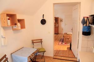 a small kitchen with a table and a room at Villa am Oberpfuhl in Lychen
