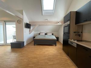 a small room with a bed in a kitchen at Schwarzfabrik in Bad Dürkheim
