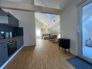 an open kitchen and dining room with a table in a room at Schwarzfabrik in Bad Dürkheim