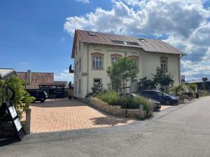 a house on a street with cars parked in front of it at Schwarzfabrik in Bad Dürkheim