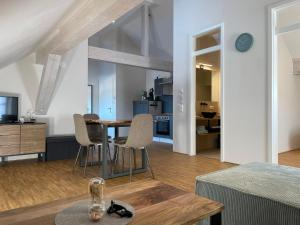 a living room and dining room with a table and chairs at Schwarzfabrik in Bad Dürkheim