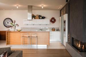 a kitchen with a counter and a fireplace at Schenna Chalet - Chalet Oasis in Schenna