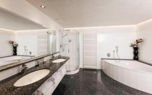 a bathroom with two sinks and a bath tub at Schenna Chalet - Chalet Oasis in Schenna +36 photos