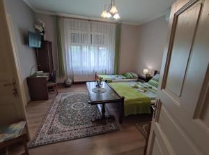 a living room with a couch and a table at Vazsita ház in Erdőbénye