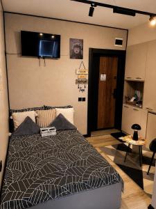 a bedroom with a bed with a television on the wall at Stayhome in Ruse