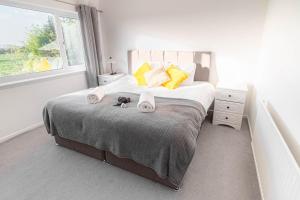 a bedroom with a bed with towels on it at 3-bedroom pet friendly home with off road parking in Swansea
