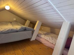 a bedroom with a bed and a ladder in a attic at Mysig lägenhet med morgondopp in Uppsala