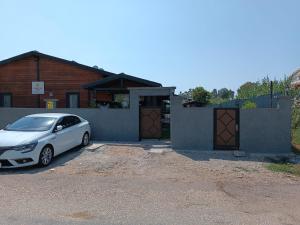 a white car parked in front of a house at Summertime Bungalows in Fethiye +1 photo