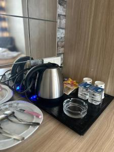 a tea kettle on a tray on a table at Carmen Suite in Esenyurt