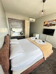 a bedroom with a large bed and a television at Carmen Suite in Esenyurt