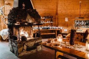 a living room with a stone fireplace in a room at Livo Arctic Resort in Posio