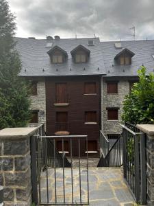 a building with a gate in front of it at Ibón de la Sierra in El Pueyo de Jaca