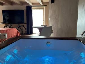 a large blue tub in a room with a bed at Lo Blan Morgex in Morgex