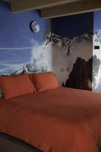 a bedroom with a bed with a mountain mural on the wall at Lo Blan Morgex in Morgex