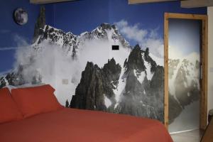 a bedroom with a mountain mural on the wall at Lo Blan Morgex in Morgex +22 photos