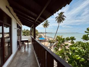 a balcony of a house with a view of the beach at Rupas Hotel in Arugam Bay