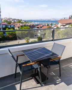 a solar table and chairs on a balcony with a view at Rossa Marin Hotel in Darıca