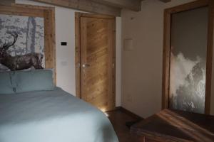 a bedroom with a bed and a wooden door at La Becca Morgex in Morgex