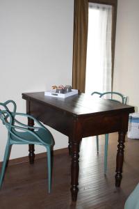 a wooden table with two chairs and a box on top at La Becca Morgex in Morgex