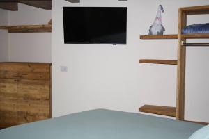 a bedroom with a flat screen tv on a wall at La Becca Morgex in Morgex +11 photos