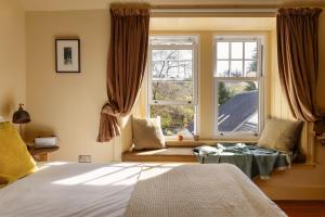 a bedroom with a bed and a window at Home Farm in Oban