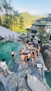 a group of people standing in a swimming pool at Lotus Premium Lodge in Ha Giang +184 photos